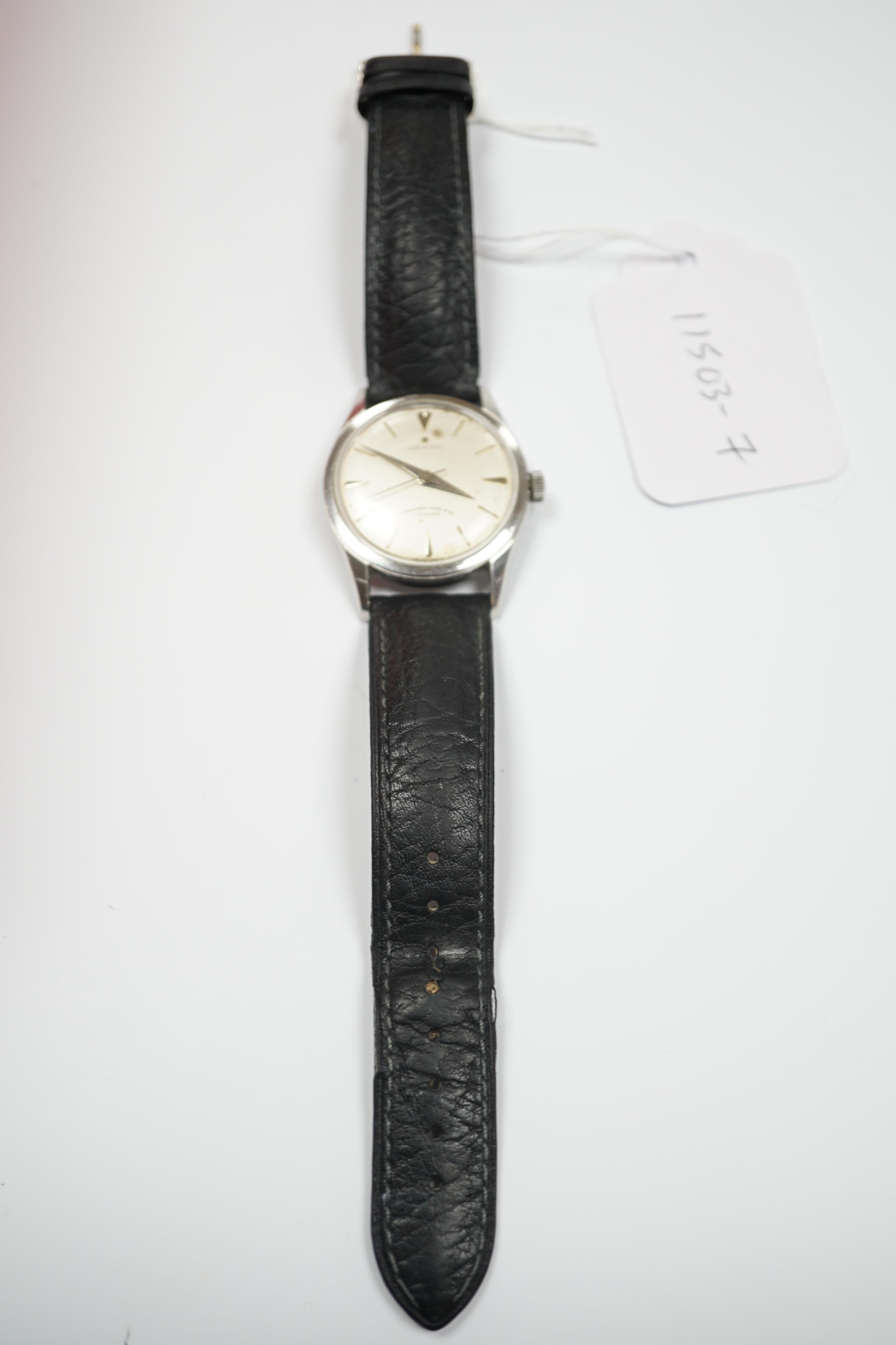 A gentleman's stainless steel Zenith manual wind wrist watch, retailed by Camerer Cuss & Co, London, on associated leather strap.